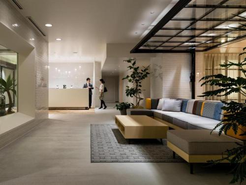 a living room with a couch and a table at Hotel Edit Yokohama in Yokohama