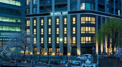a large building with lights on in a city at Hotel Edit Yokohama in Yokohama