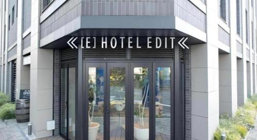 a building with a sign on the front of it at Hotel Edit Yokohama in Yokohama