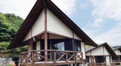 a house with a thatched roof at Hotel Bellreef Otsuki in Otsuki