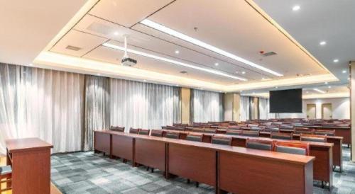 a lecture hall with rows of desks and a podium at Lavande Hotels· Guizhou Anshun Xi Railway Station in Anshun