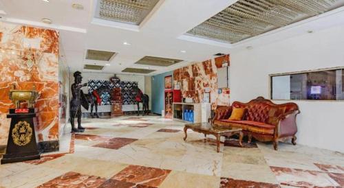 a living room with a couch and a fireplace at GreenTree Alliance Anhui Hefei South Passenger Station South High Speed Railway Station Hotel in Hefei