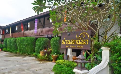 a building with a sign in front of it at Nan Lanna Hotel in Nan