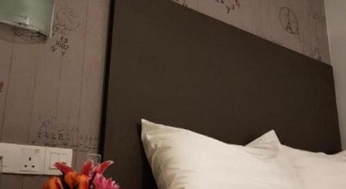 a bed with a black headboard and a white pillow at City View Hotel At KLIA & KLIA2 in Kuala Lumpur