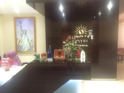 a conference room with a table with a picture of the statue of liberty at Sunrise Hotel Cameria in Durrës
