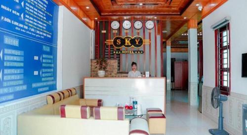 a man sitting at a counter in a restaurant at SKY HOTEL - KHÁCH SẠN BẮC NINH in Bắc Ninh