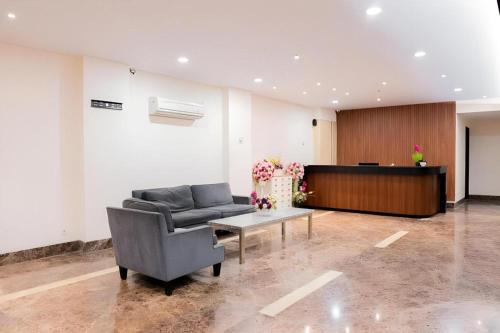 a living room with a couch and a table at Life Hotel Soekarno Hatta Makassar in Makassar