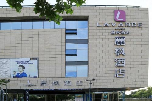 a building with a sign on the side of it at Lavande Hotels Suzhou Railway Station in Suzhou