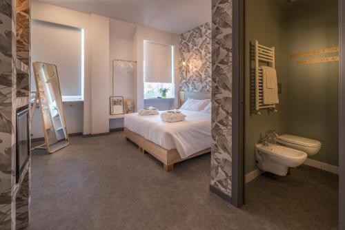 a bedroom with a bed and a sink and a toilet at Hotel Villa Eur in Rome