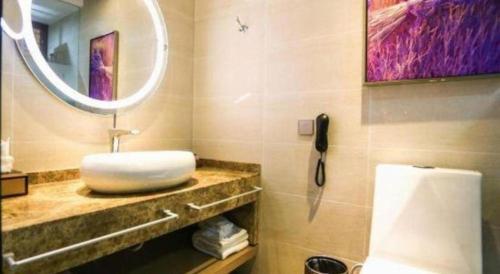 a bathroom with a sink and a mirror at Lavande Hotel Xi'an Longshouyuan Wenjing Road in Xi'an