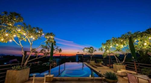 a house with a swimming pool at night at The B Ranong Trend Hotel in Ranong