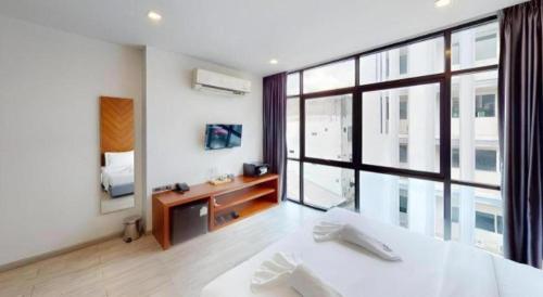 a large room with a large window and a bed at INBED in Sadao
