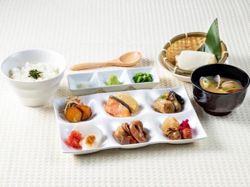 a plate of food on a table with rice at KEIKYU EX INN Haneda Innovation City 2 minutes walk from HICity Exit of Tenkubashi Station in Tokyo
