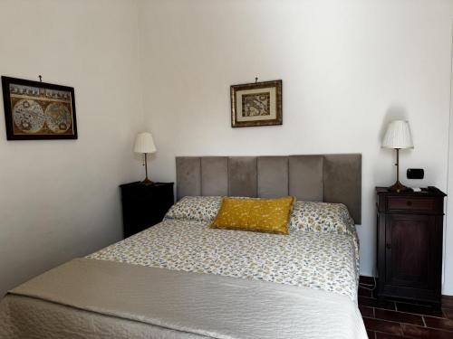 a bedroom with a bed with a yellow pillow on it at B&B La Meta in Benevento