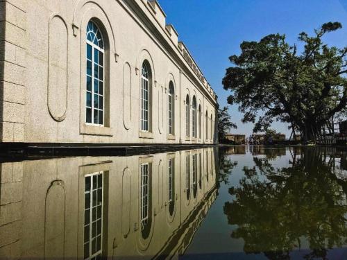 a building with its reflection in a body of water at London Hotel in Macau