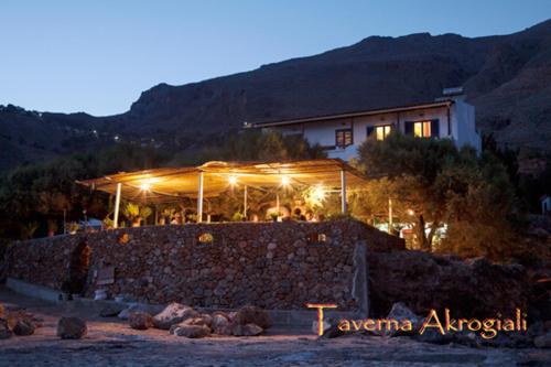 
a building with a fire place on the top of it at Taverna Akrogiali in Loutro
