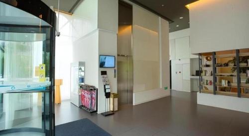a large room with a glass door and a room with at Jinjiang Inn Select Shanghai Fengxian Baolong Square North Yunhe Road in Shanghai