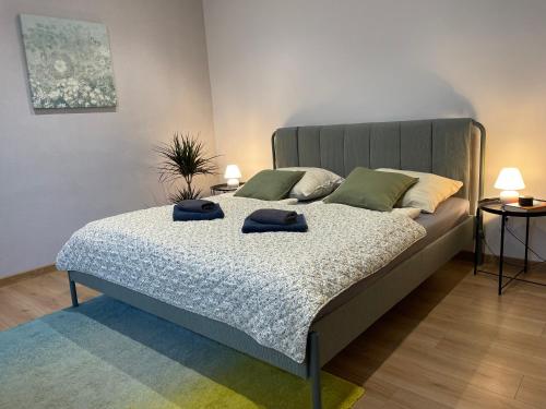 a bedroom with a bed with two hats on it at Atlas suites WEST in Košice