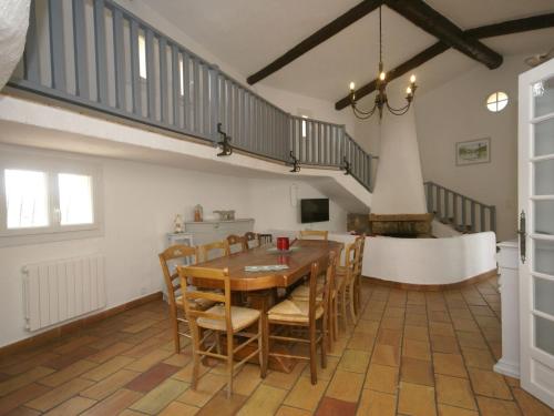 a dining room with a wooden table and chairs at Spacious villa with garden near Grasse in Mouans-Sartoux