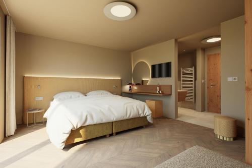 a bedroom with a large bed and a television at Adults only Hotel Grafenstein in Schenna