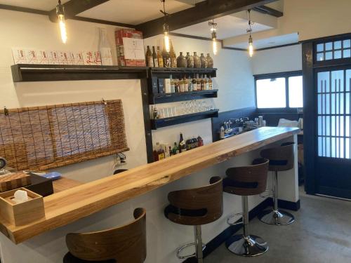 a bar with bar stools in a room at fujisakaya藤坂屋 in Tamba-sasayama