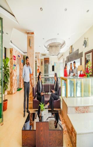 a group of people sitting in a lobby at FabHotel Marble Arch Karol Bagh in New Delhi