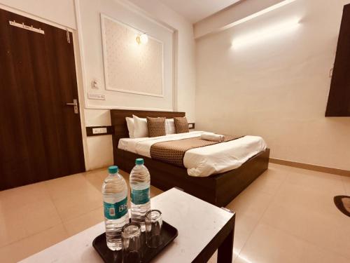 a hotel room with two water bottles on a table at Majestic Heights Hotel in Jaipur