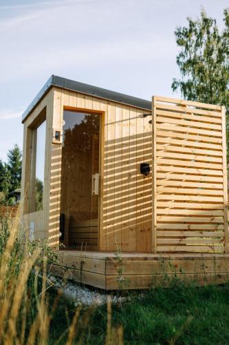 a small wooden house with a large door at Patri's glamp in Mariánské Lázně