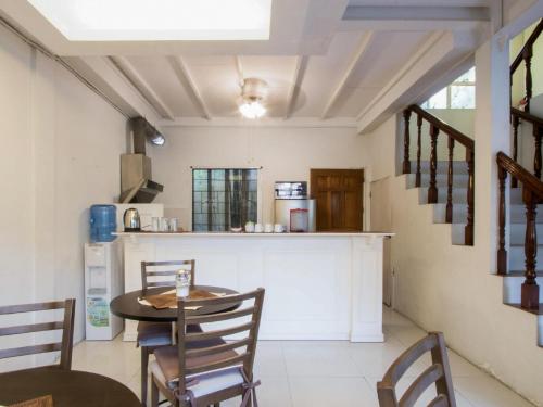 a kitchen with a table and chairs and a counter at Makati Riverside Inn in Manila