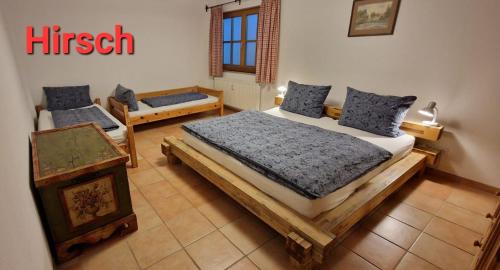 a bedroom with a bed and two chairs in it at FeWo Holzwarth Oberammergau in Oberammergau