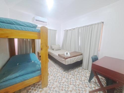a bedroom with two bunk beds and a desk at Big Family Space - 3 AC Bedrooms in Apia
