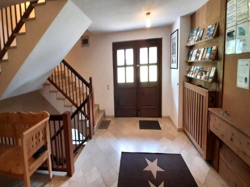 a hallway with a staircase and a door with a star on the floor at Lush apartment in Bayrischzell with 2 saunas in Bayrischzell