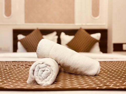 a rolled up towel on a table in a hotel room at Majestic Heights Hotel in Jaipur