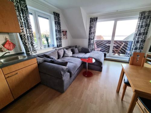 a living room with a couch and a table at Ferienwohnung Weitblick Breege in Breege