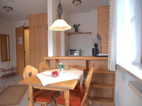 a kitchen with a wooden table and chairs and a table at Lush apartment in Bayrischzell with 2 saunas in Bayrischzell