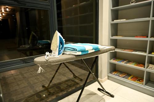 a table with towels on it in front of a closet at Modern spacious 4-bedroom home in Victoria Falls