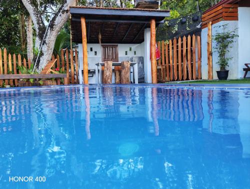 a pool of water in front of a house at Ely Field Villa in Galle