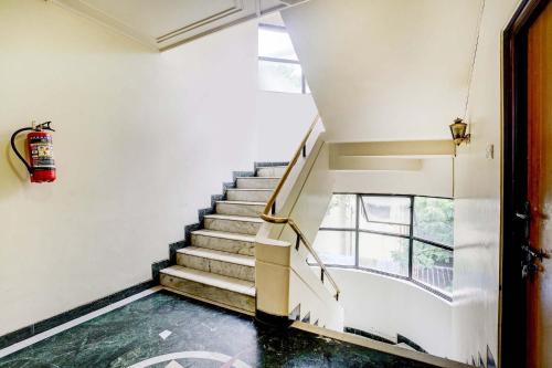 a staircase in a building with a fire hydrant at FabHotel Ratna Regency in Chinchiwad