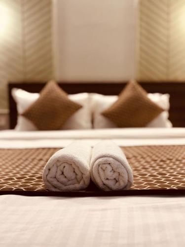 a couple of towels sitting on top of a bed at Majestic Heights Hotel in Jaipur