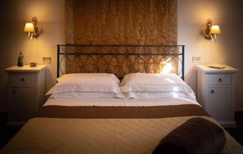 a bedroom with a bed with white pillows at Bella di Ceciliano in Arezzo