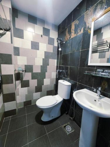 a bathroom with a toilet and a sink at Boutique Hote123 in Kuala Lumpur