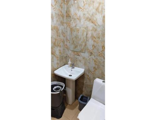 a bathroom with a sink and a toilet at Shree Ram Swaroop vatika, Chitrakoot Dham in Karwi