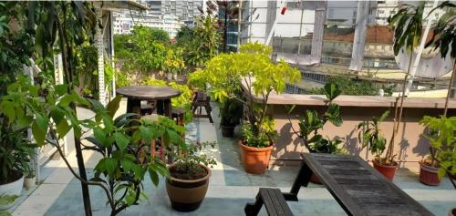a balcony with tables and potted plants on a building at Boutique Hote123 in Kuala Lumpur