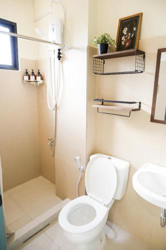a bathroom with a toilet and a sink at Roseco Building in Davao City