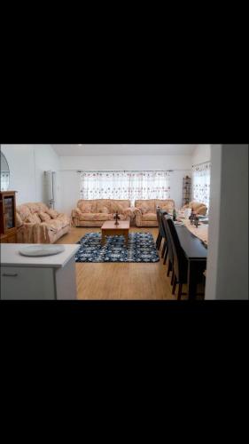 a living room with a couch and a table at Lina and Fanga's holiday home in Kolomotua