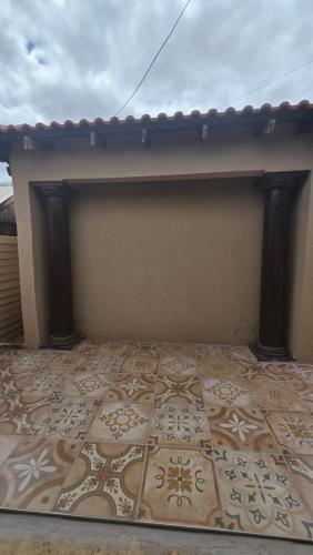 a room with a wall with a tile floor at Akwaaba Fie Guesthouse in Lebowakgomo