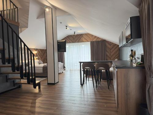 a kitchen and living room with a table and chairs at Didukh Eco Hotel&Spa in Bukovel