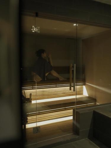 a person sitting on a bench in a building at N3 ATAMI-Forest- in Atami