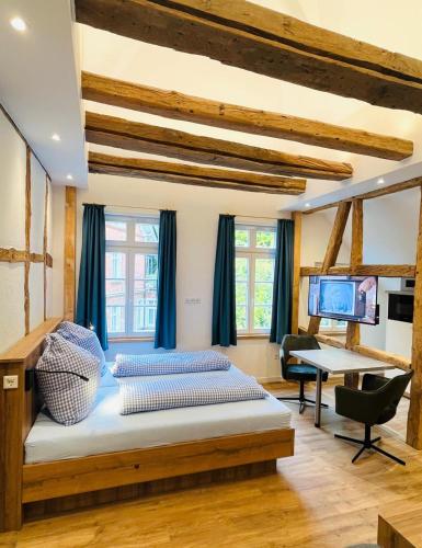 a bedroom with a bed and a desk and a television at Eibenhaus in Bad Iburg
