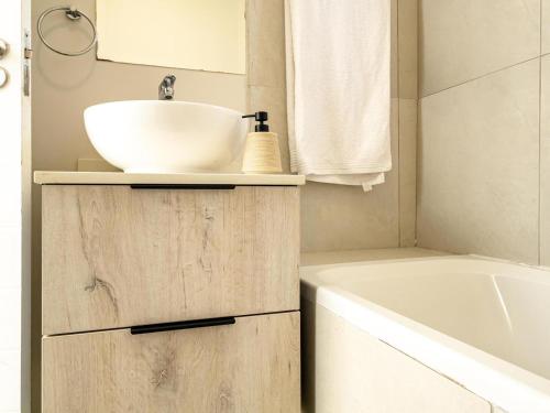 a bathroom with a sink and a bath tub at The Sweet Serenity Suite in Midrand